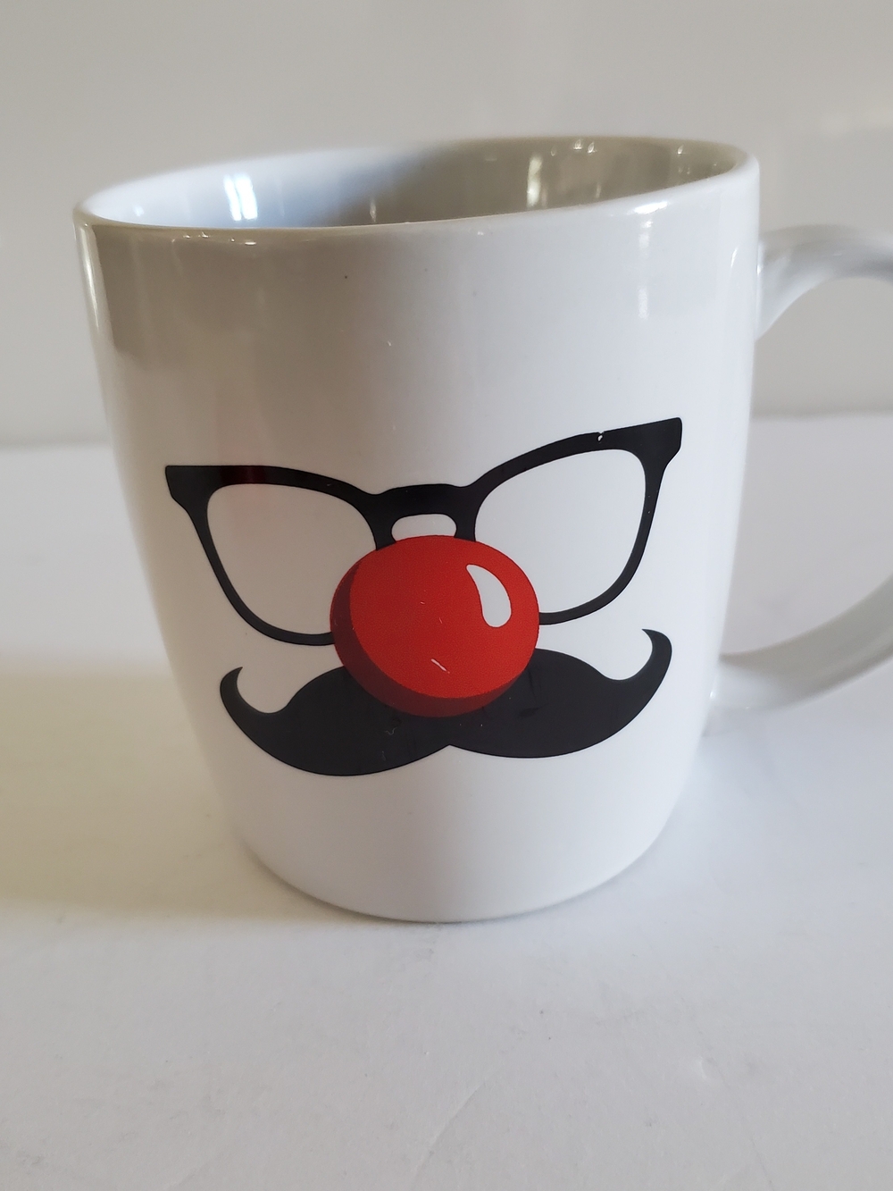 Red Nose Day. White Ceramic Mug with Black Glasses & Mustache and Red Nose